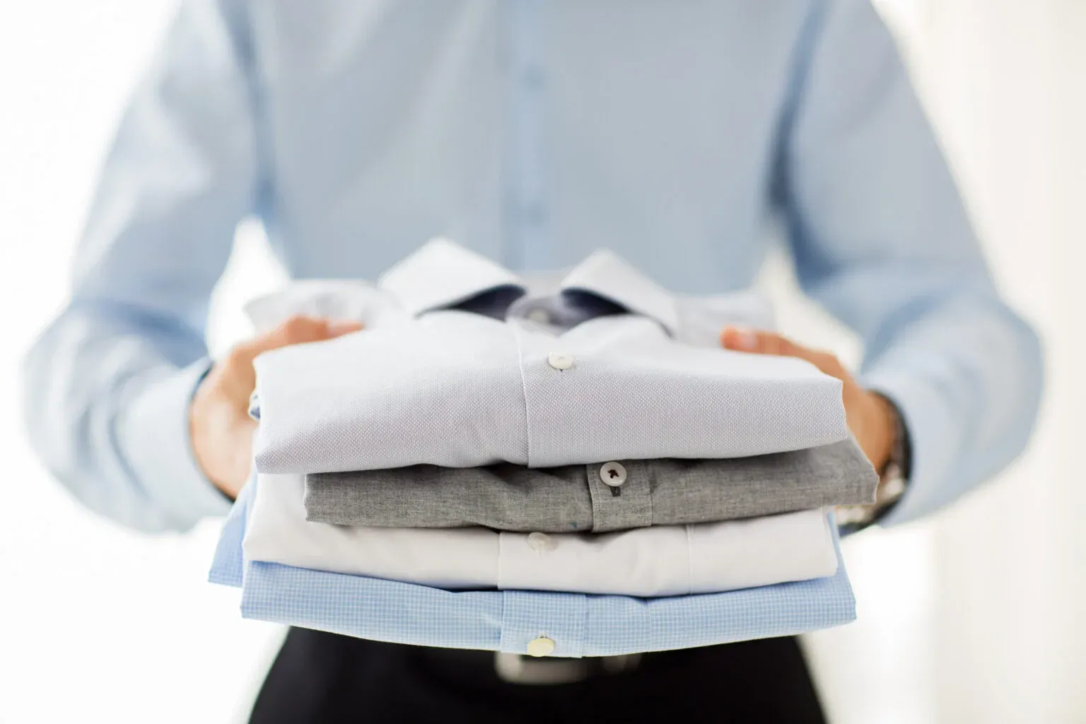 Commercial laundry service for businesses in Bahrain — folded shirts and linen
